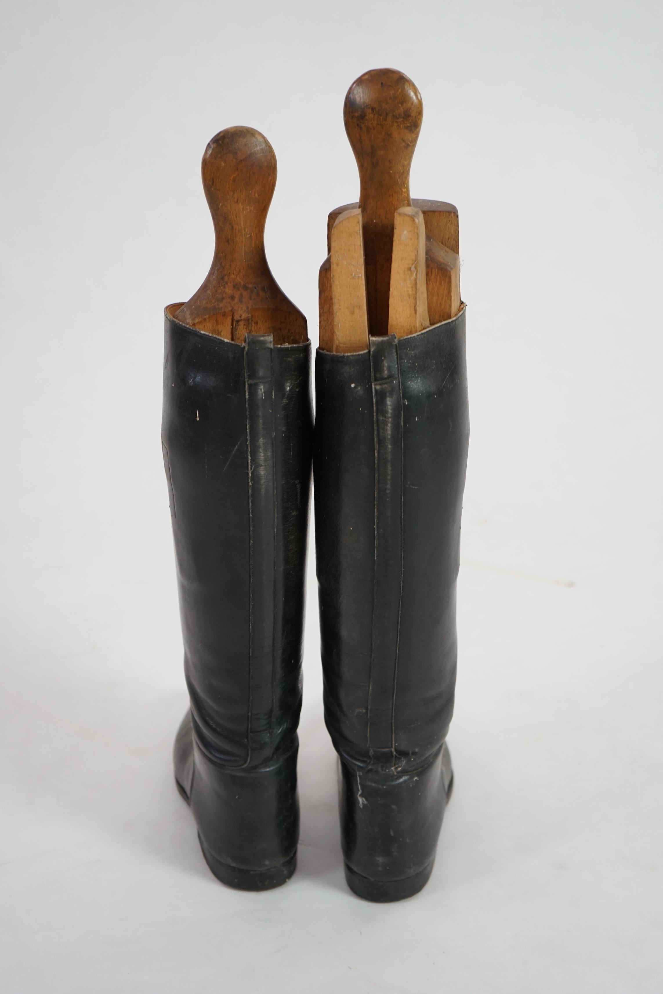 A pair of black leather riding boots